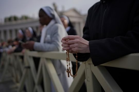 A nun holds a rosary as she waits for the funeral of Pope Francis