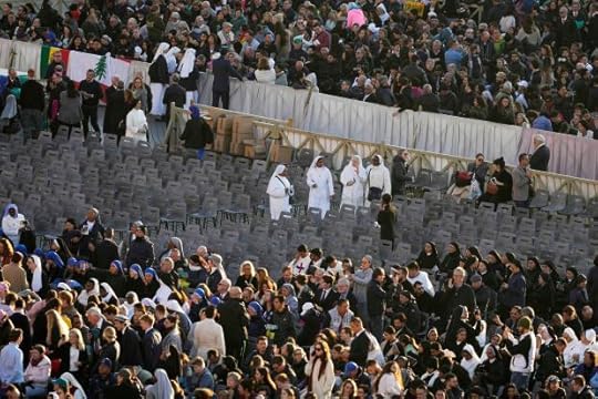 Nuns and other pilgrims look for their seats in St. Peter's Square