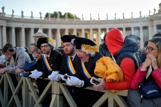 A man yawns as people arrive in St. Peter's Square
