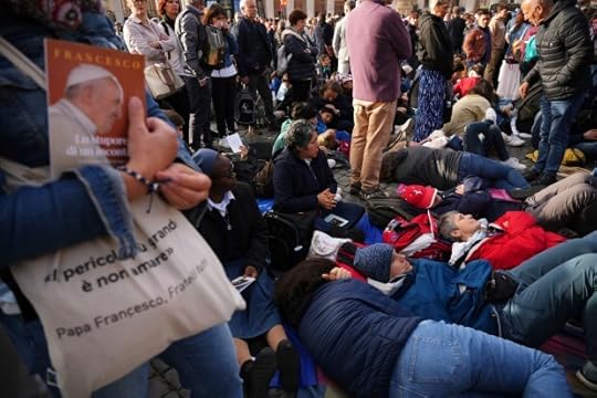 Faithful rest on the ground outside St Peter's Basilica