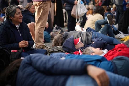 Faithful rest on the ground ahead of the funeral of Pope Francis