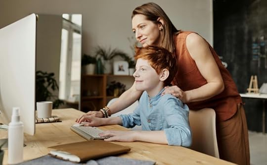 child learning through tech based apps on computer with smiling mom