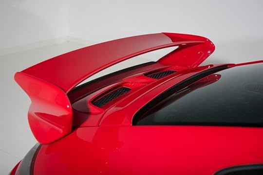 Custome aero piece for car, The spoiler of a red sports car in a white room