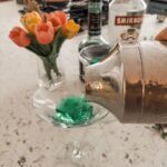 The shaker pouring out the finished classic 60s cocktail