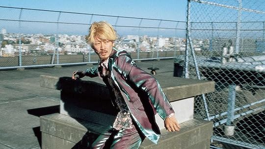 A bleached blond Tadanobu Asano traverses a rooftop in