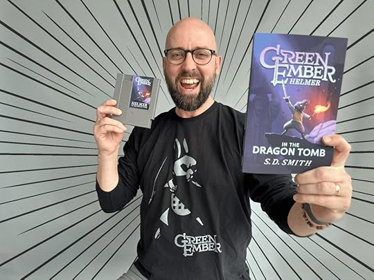 Green Ember Author holding Helmer book