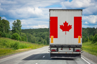 Big-truck-with-national-flag-canada-moving-highway_1200_t
