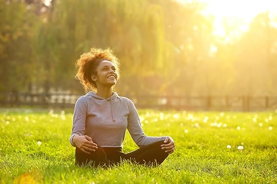 Image of a happy woman sitting on the ground looking up toward the sky. With the help of a skilled therapist, you can begin to improve your impulse control and decision making skills with the help of DBT used in an Adult IOP in Houston, TX.