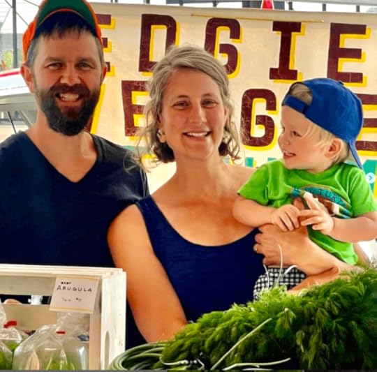 Farm family at farmers market selling produce