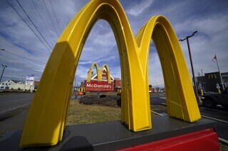 McDonald's restaurant signs are shown in in East Palestine, Ohio, Feb. 9, 2023. McDonald's reports earning on Monday, July 29, 2024. (AP Photo/Gene J. Puskar, File)