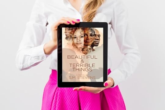 woman wearing white blouse and hot pink skirt, holding a tablet with the book cover