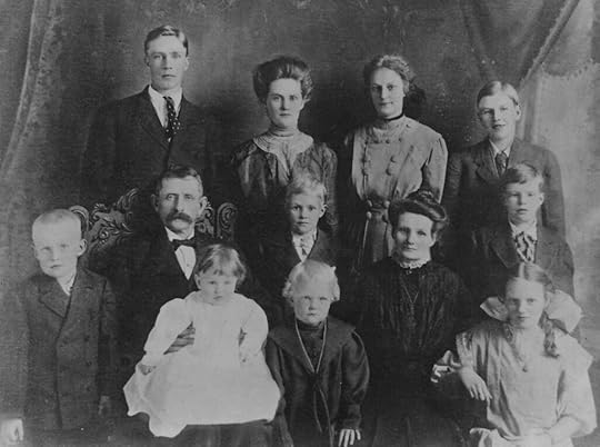 A family in 1909 in their Sunday best clothes. There are seven boys and three girls plus the mother and father.