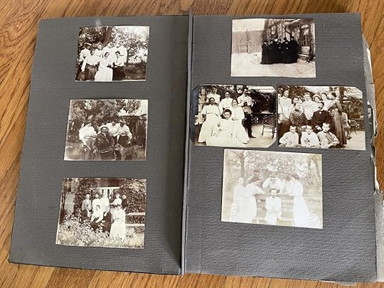 An old photo album interior with faded photos from the nineteenth century.