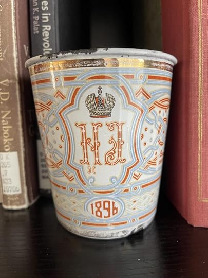 An old decorative enameled cup from the coronation of Tsar Nicholas II with the initials of the Tsar and Tsarina and the year 1896.
