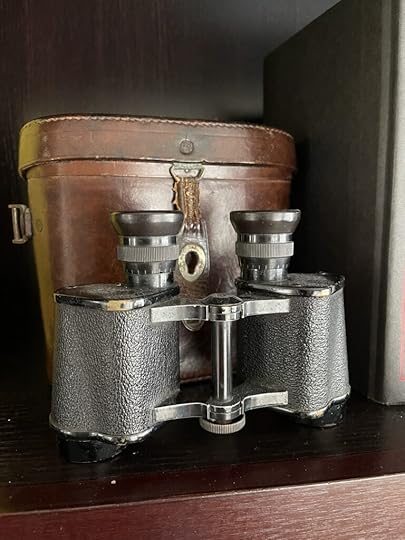 An old pair of binoculars from the nineteenth century with their brown leather case.
