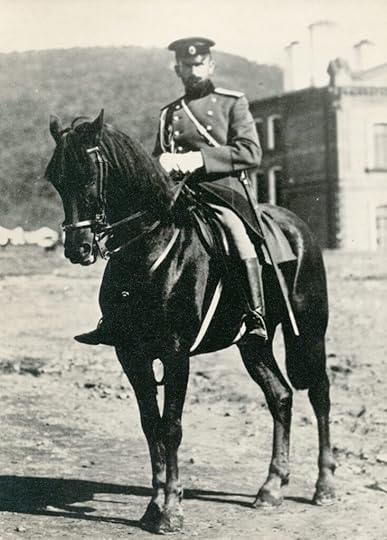 Old photo of a nineteenth century Russian officer on a beautiful black horsse.