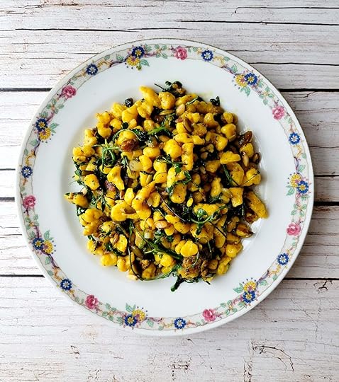 A plate of squash spaetzle with greens.
