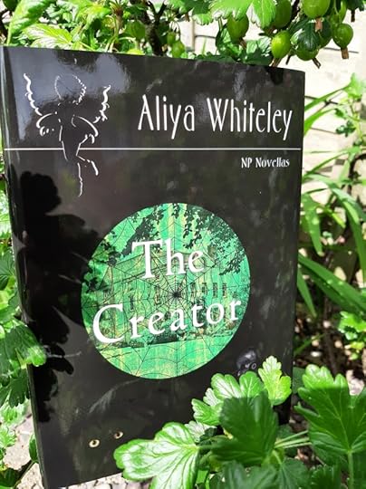 A photograph of the hardback novella 'The Creator' in foliage.