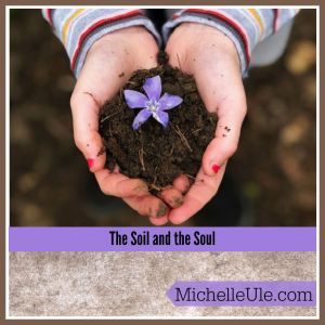 Hands holding soil and the soul