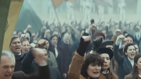 Ghormans raise their hands in protest in a public square on Andor