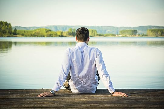 Relaxed man sitting on a wooden pier next to a lake. If you are feeling stuck and in the same unhealthy patterns, find support in coping and overcoming those patterns with DBT i an adult intensive outpatient program in Houston, TX.