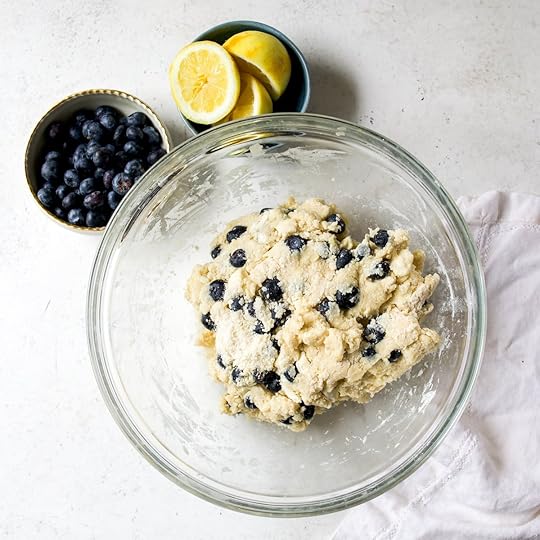 Lemon blueberry scone dough in a clear glass bowl.