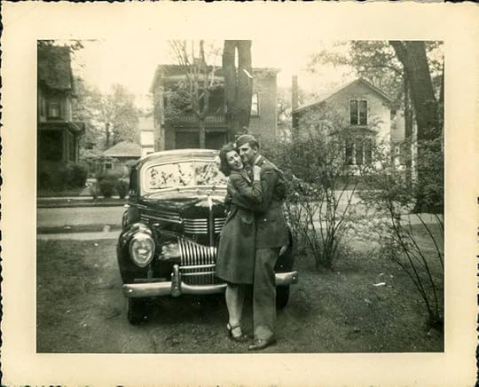 a yellowed photo with a young dark-haired girl hugging a young man in uniform. 