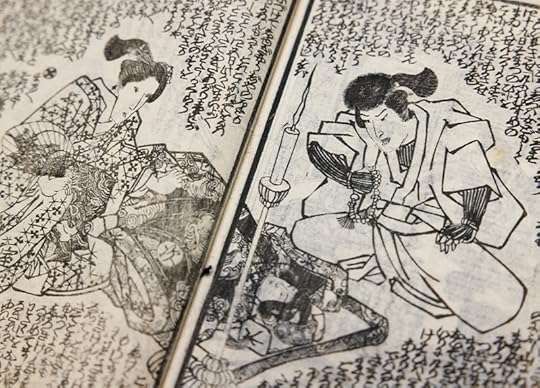 Medium closeup of two open pages filled with two drawings of a man one one page and a woman on another, the typeface filling every part of the page.