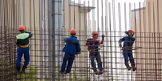 steel workers climbing on rebar