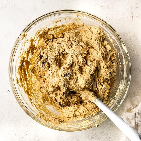 A glass bowl filled with chocolate chip peanut butter cookies.