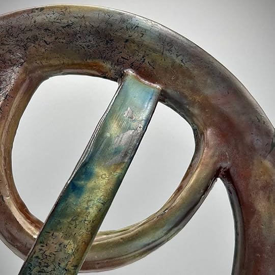 Close-up of a sculptural piece from the 'Liminal Dreams' series, showcasing curved forms with a metallic finish and interwoven elements.