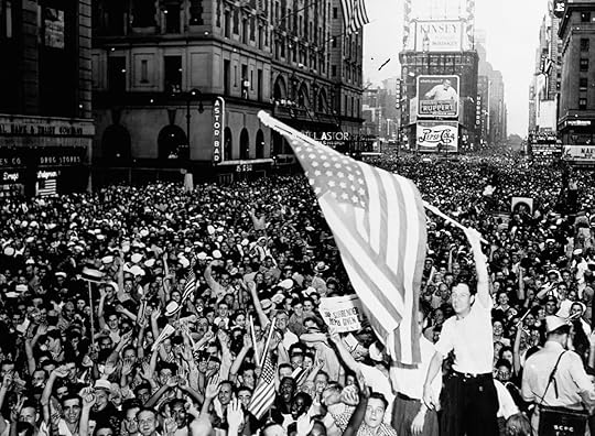 A historic black-and-white photograph of a large crowd gathered in Times Square, New York City, celebrating the end of World War II on V-J Day (Victory over Japan Day) in August 1945. The image shows thousands of people waving American flags and cheering. Prominent buildings, including the Astor Hotel and various advertisements such as Pepsi-Cola, are visible in the background. The atmosphere is jubilant and patriotic, with people packed closely together in the iconic square.
