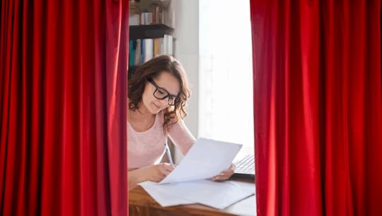 writer revealed behind a curtain