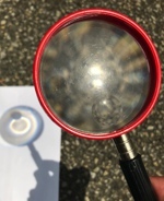 A magnifying glass with paper