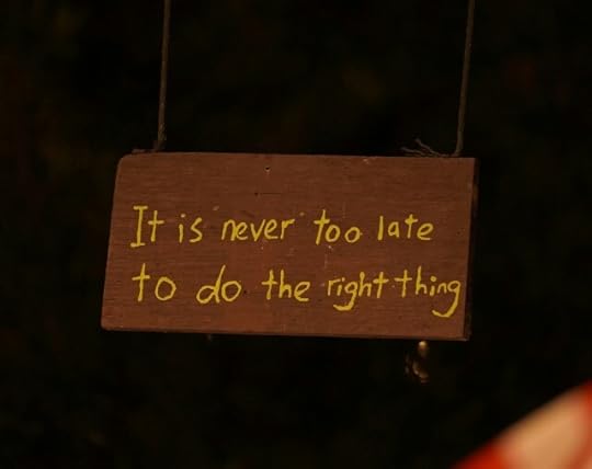 A sign reading “it’s never too late to do the right thing.”