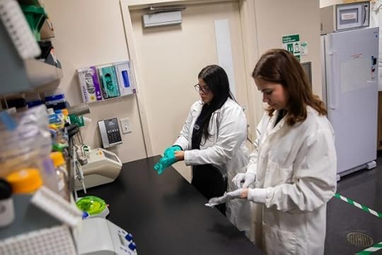Marisa Mendoza, right, and Camila Valderrama-Martínez, left, get ready to demonstrate how they use lab equipment for their research work at Cal State San Marcos on May 6, 2025. (Adriana Heldiz - CalMatters)