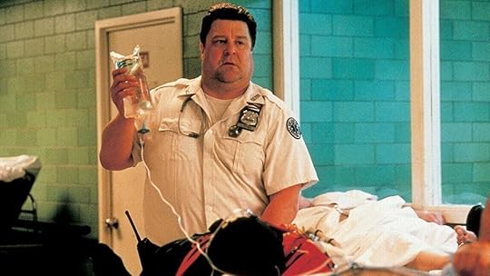 John Goodman holds up an IV bag in