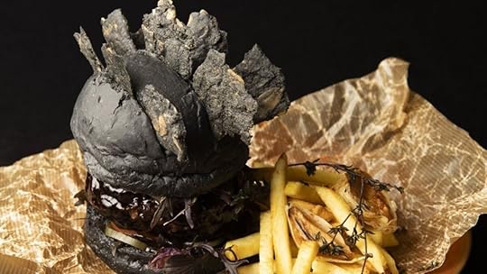 image of a black godzilla burger with spikes on the bun 