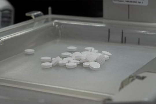 Pills sit in the tray of a pill-counting machine