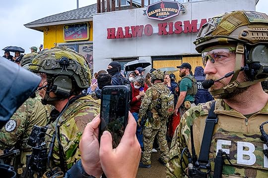 ICE, ATF, and FBI officers are confronted by protesters as...