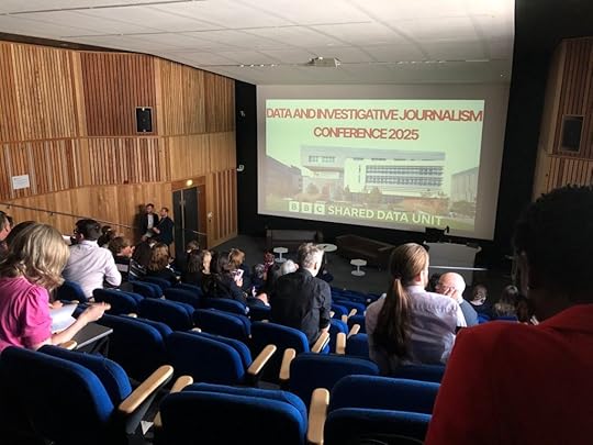 Attendees in a lecture theatre with 'data and investigative journalism conference 2025 BBC Shared Data Unit' on the screen.