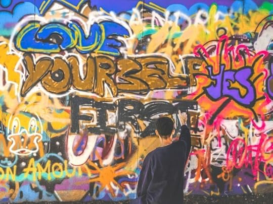 Graffiti that reads “love yourself first. Yes.” You are what you believe that you are.