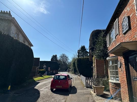 Road through Chawton, houses, red car, blue sky