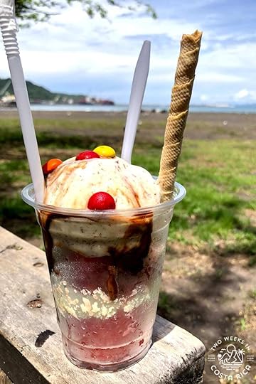 a granizado ice cream with caldera beach in the background
