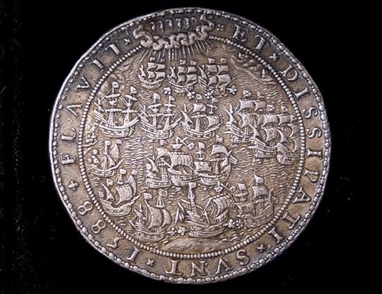 A round silver medal, emblazoned with more than a dozen sailing ships. At the top, a cloud blows wind downward, showing the blustery weather that sent Spanish ships scattering during their retreat.