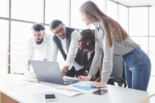 Team collaborating at computer to illustrate the idea that AI can't save bad strategy.