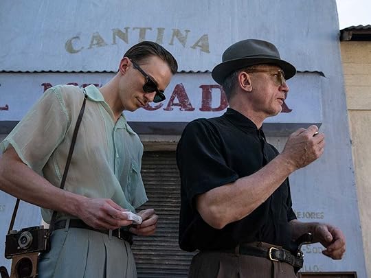 Drew Starkey and Daniel Craig smoke cigarettes outside a building that says