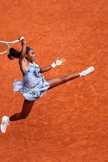 Coco Gauff jumps to play a forehand return to Belarus' Aryna Sabalenka during their women's singles final match on day 14 of the French Open tennis...