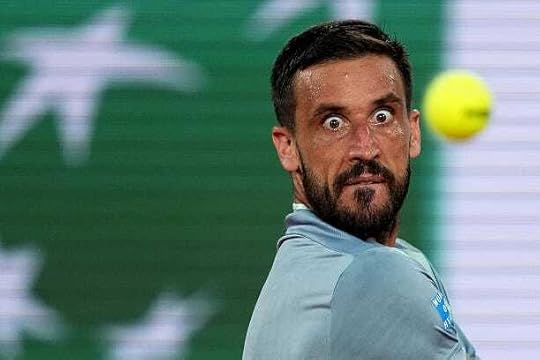 Bosnia and Herzegovina's Damir Dzumhur eyes the ball as he plays a backhand return to Spain's Carlos Alcaraz during their men's singles match on day...