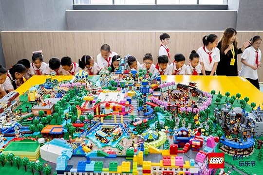 Kids admiring a colorful giant LEGO set in Shanghai for LEGO World Play Day